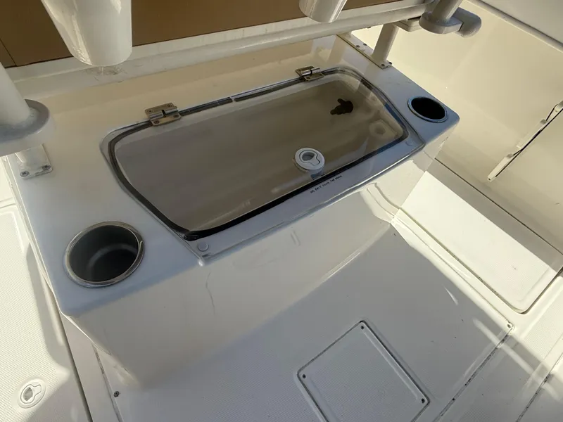 Slide: The Image of 2022 Trophy T24CC boat deck with livewell and cup holders. - 16