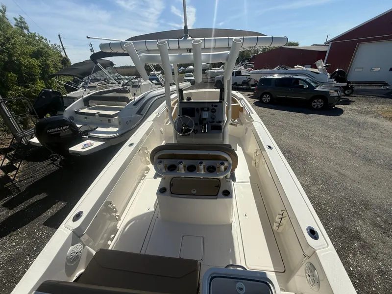 Slide: The Image of 2022 Trophy T24CC boat with center console, docked outdoors under clear sky. - 18