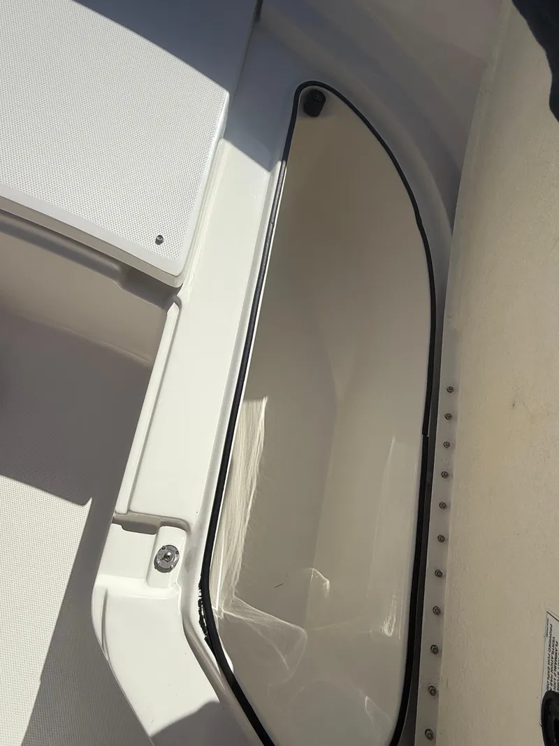 Slide: The Image of 2022 Trophy T24CC boat storage compartment with open hatch, showcasing interior space. - 7