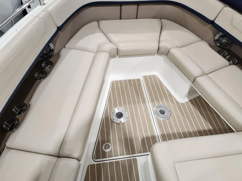 Slide: The Image of 2018 Formula 350 CBR boat interior with beige seating and wood-patterned flooring. - 11