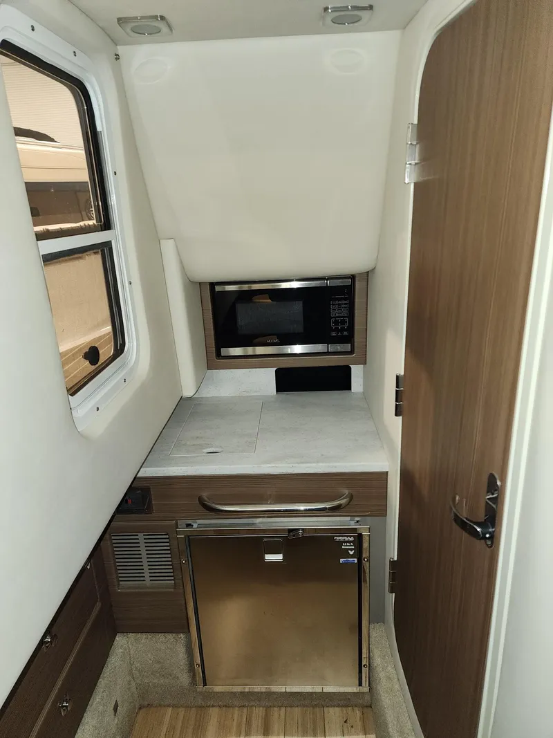 Slide: The Image of 2018 Formula 350 CBR cabin interior with microwave and compact fridge. - 12