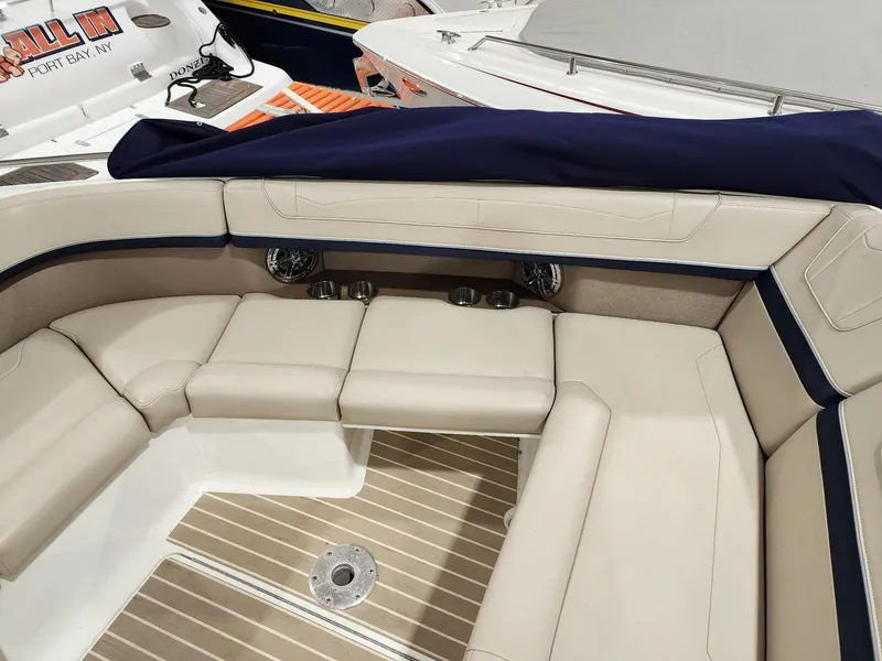 Slide: The Image of 2018 Formula 350 CBR boat interior with beige seating and wood flooring. - 14