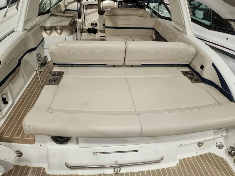 Slide: The Image of 2018 Formula 350 CBR boat interior with beige seating and wood flooring. - 16