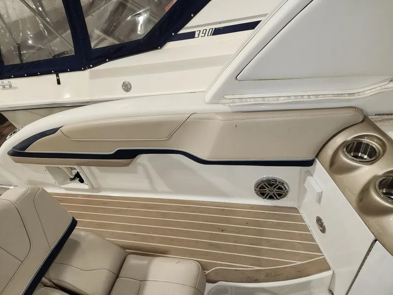 Slide: The Image of 2018 Formula 350 CBR boat interior with beige seating, cup holders, and wood-style flooring. - 17
