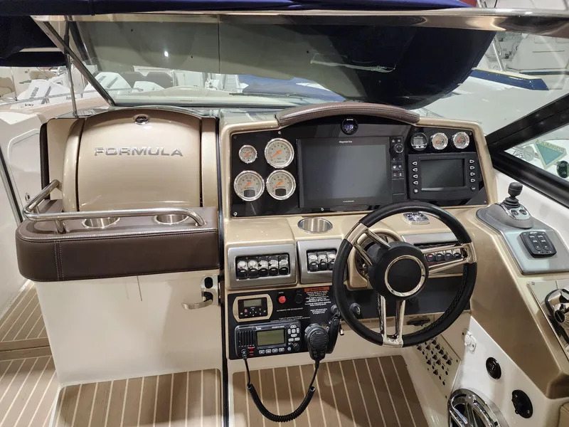 Slide: The Image of 2018 Formula 350 CBR boat dashboard with steering wheel and navigation controls. - 18