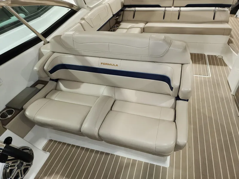 Slide: The Image of 2018 Formula 350 CBR boat interior with beige leather seating and striped flooring. - 20
