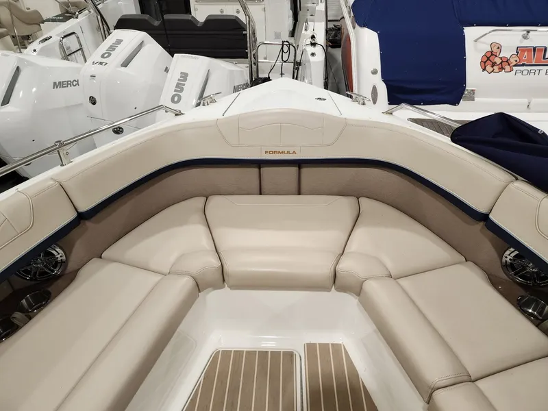 Slide: The Image of 2018 Formula 350 CBR boat interior with beige seating and wood accents. - 22