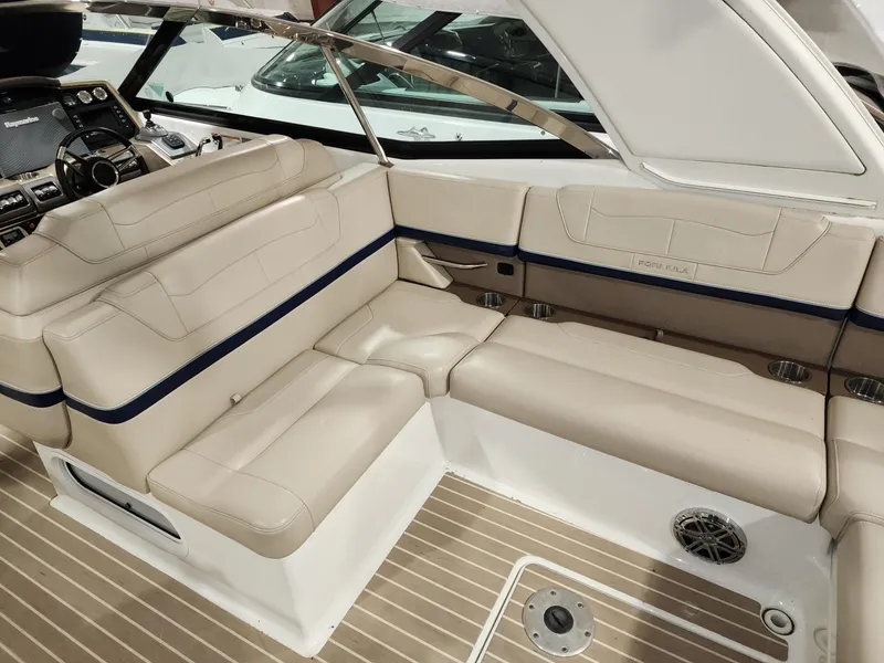 Slide: The Image of 2018 Formula 350 CBR boat interior with beige seating and modern dashboard. - 23