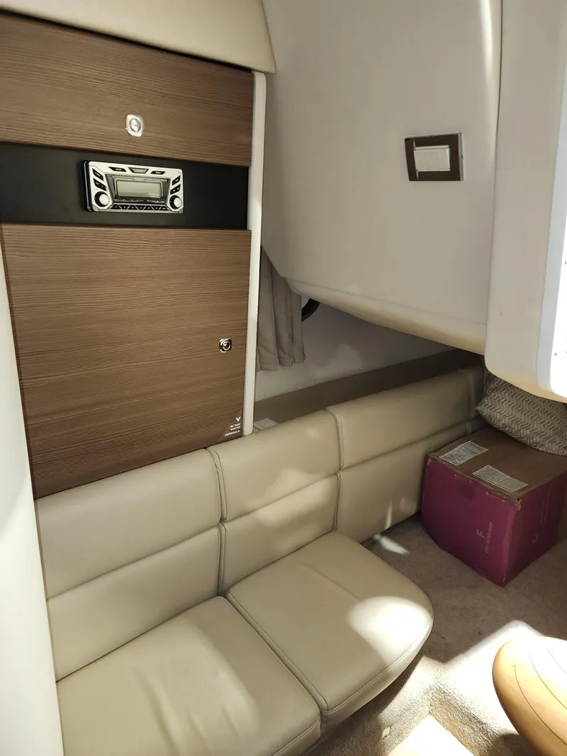 Slide: The Image of 2018 Formula 350 CBR cabin interior with beige seating and modern wood paneling. - 24