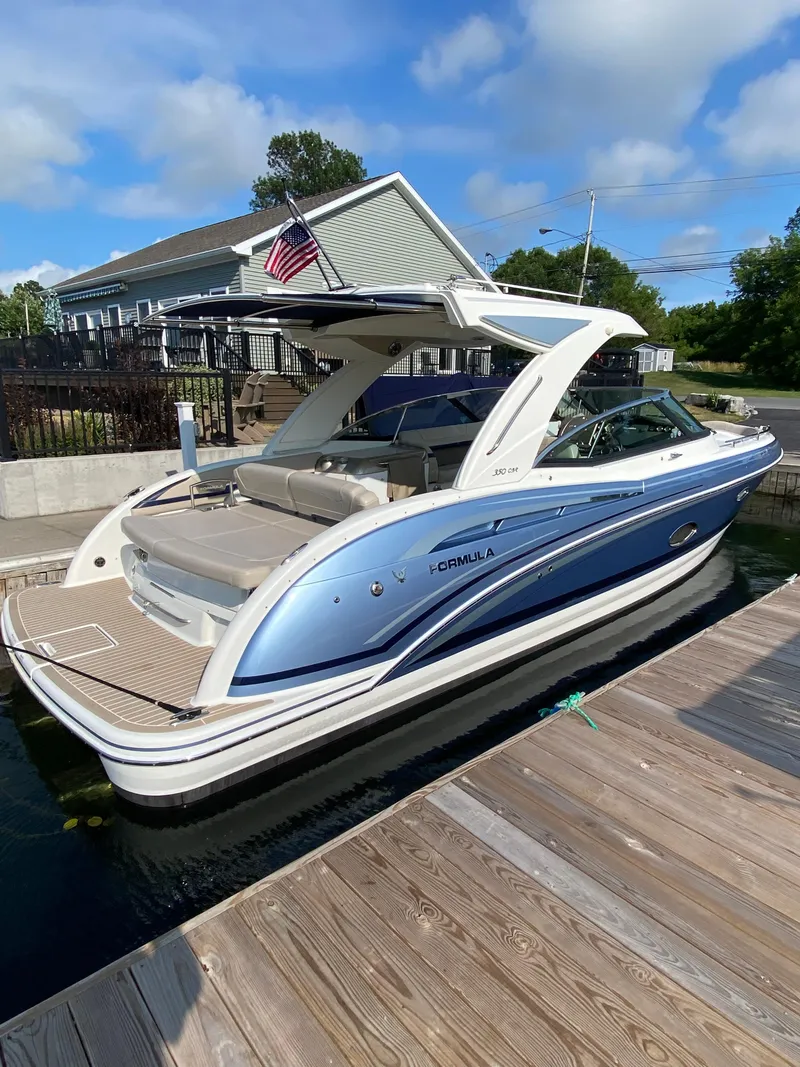 Slide: The Image of 2018 Formula 350 CBR boat docked, featuring sleek design and American flag. - 4