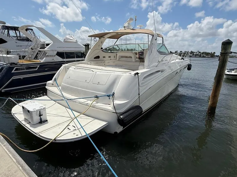 Slide: The Image of 2000 Sea Ray 510 Sundancer yacht docked at marina under blue sky. - 1