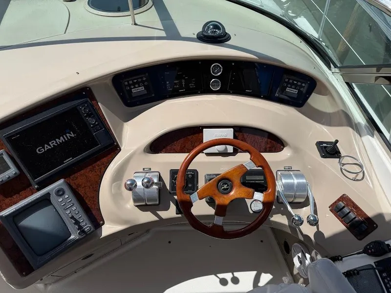 Slide: The Image of Cockpit of 2000 Sea Ray 510 Sundancer with Garmin navigation and wooden steering wheel. - 10