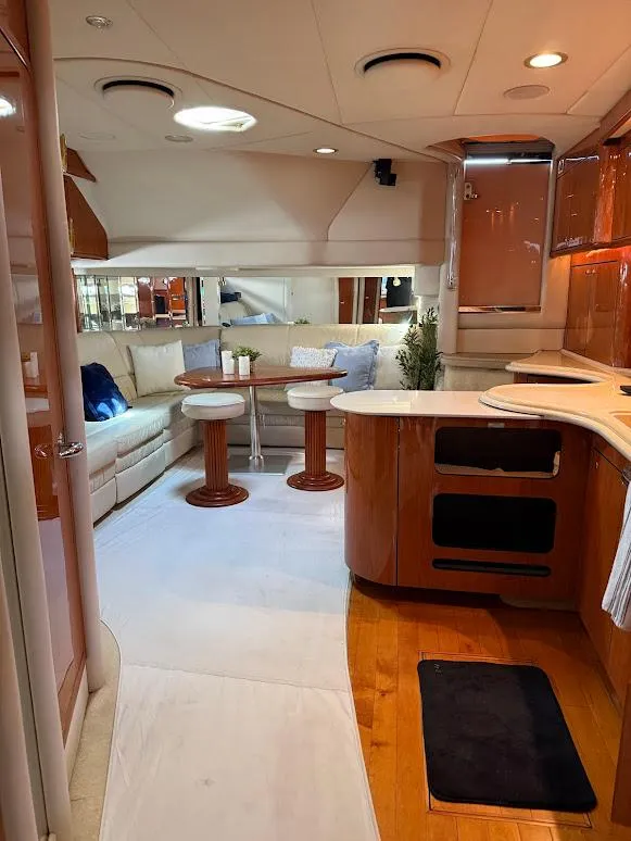 Slide: The Image of Luxurious interior of 2000 Sea Ray 510 Sundancer yacht with modern kitchen and cozy seating area. - 12