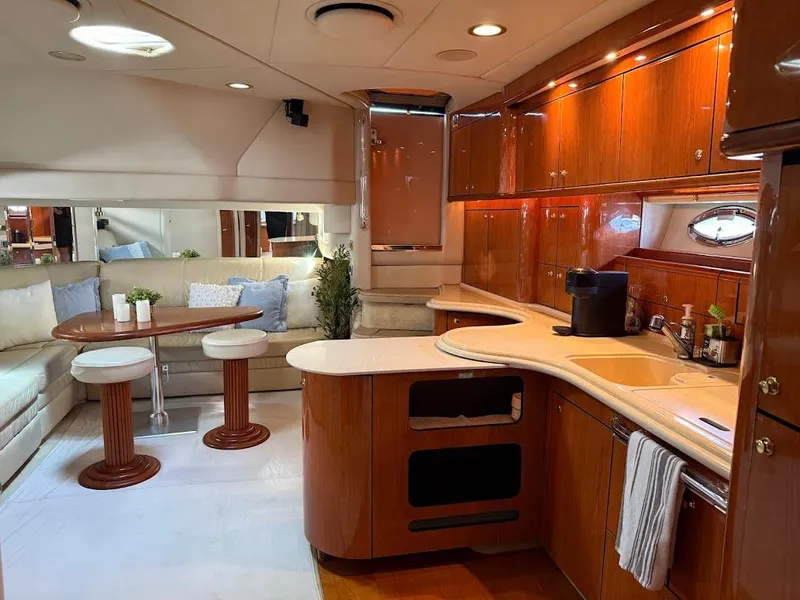 Slide: The Image of Luxurious interior of 2000 Sea Ray 510 Sundancer yacht with elegant wood cabinetry and cozy seating. - 13