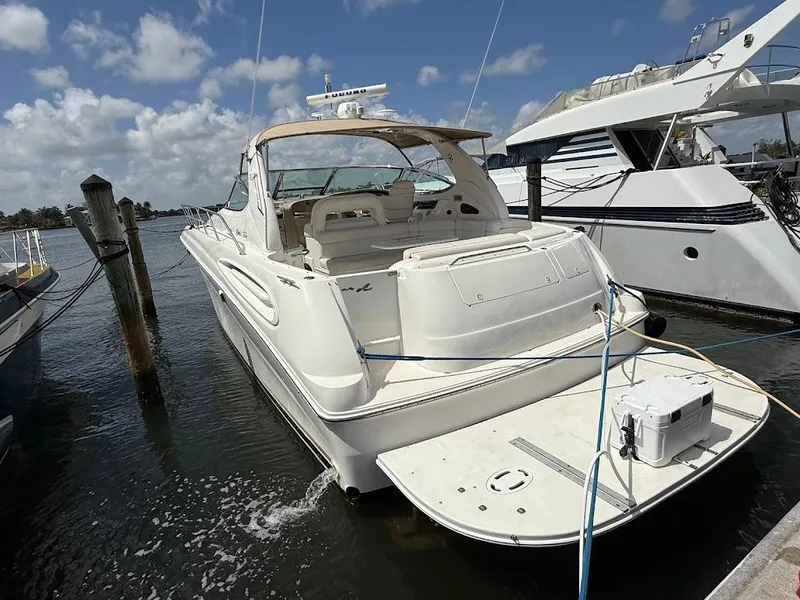 Slide: The Image of 2000 Sea Ray 510 Sundancer yacht docked at marina under blue sky. - 2