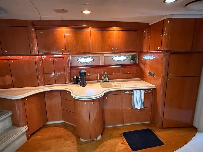 Slide: The Image of Luxurious kitchen interior of 2000 Sea Ray 510 Sundancer yacht with wooden cabinetry. - 23