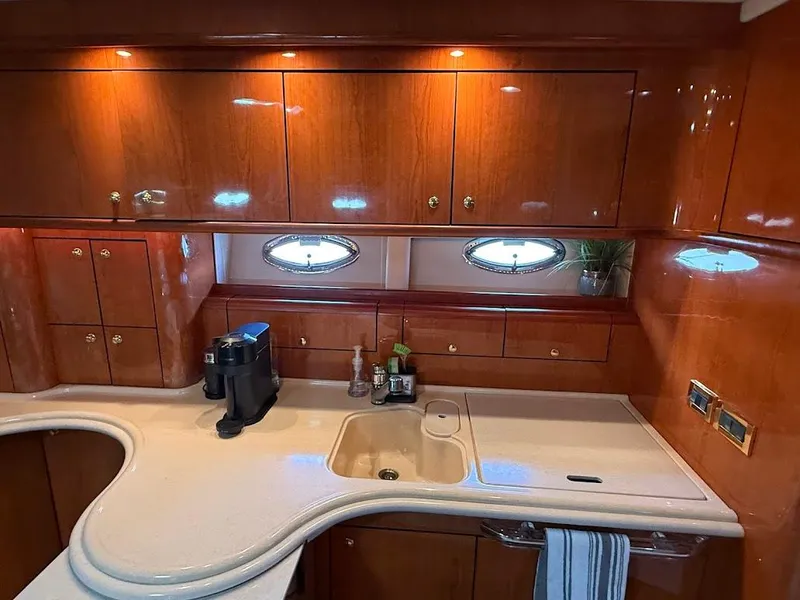 Slide: The Image of Luxurious kitchen interior of 2000 Sea Ray 510 Sundancer yacht with wooden cabinets and modern amenities. - 25