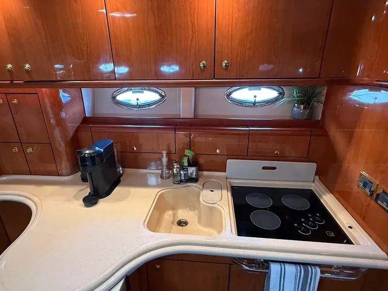 Slide: The Image of Luxurious kitchen interior of 2000 Sea Ray 510 Sundancer yacht with modern amenities. - 26