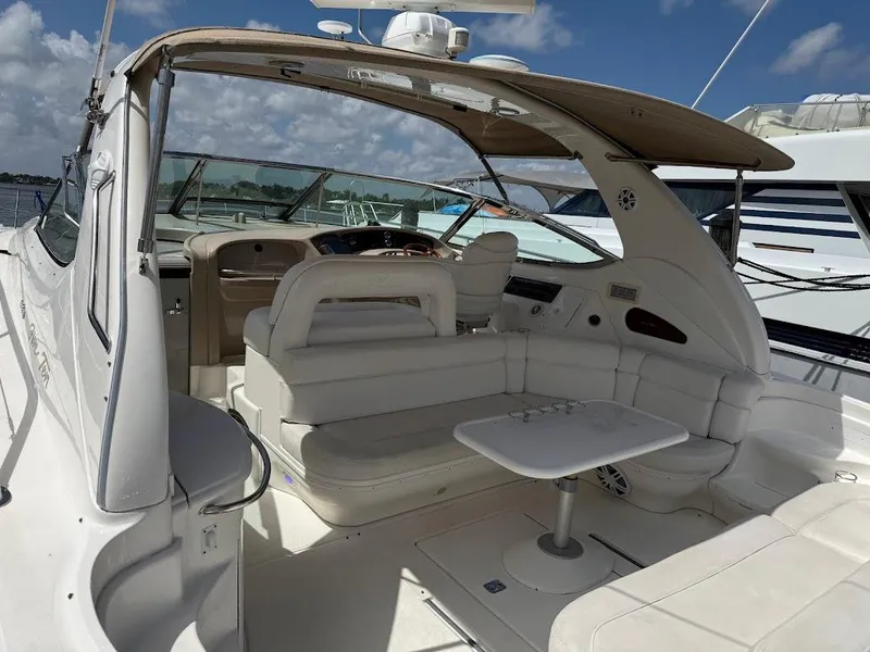 Slide: The Image of 2000 Sea Ray 510 Sundancer yacht interior with seating and table under canopy. - 6