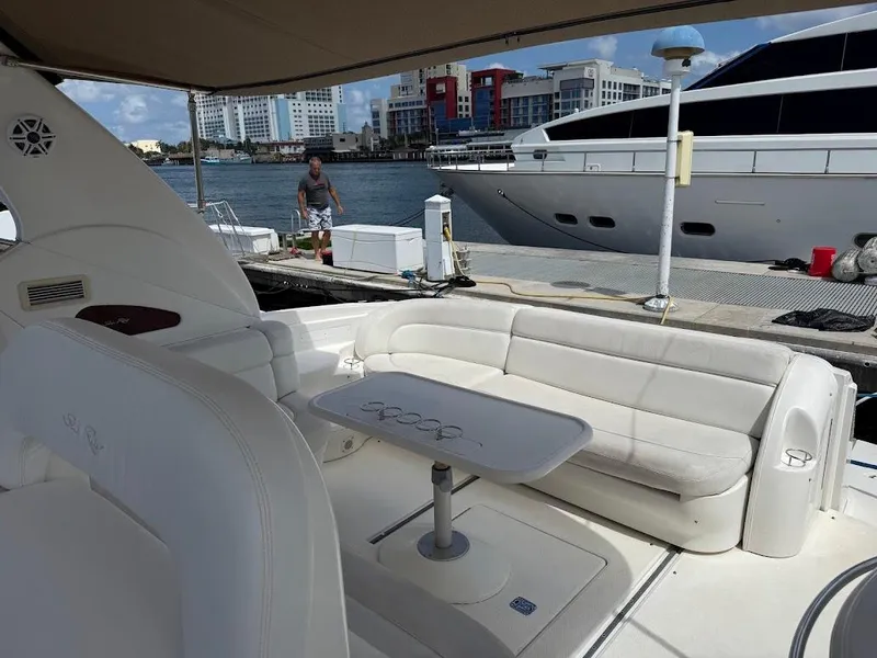 Slide: The Image of Luxurious 2000 Sea Ray 510 Sundancer yacht interior with white seating and table, docked at marina. - 7