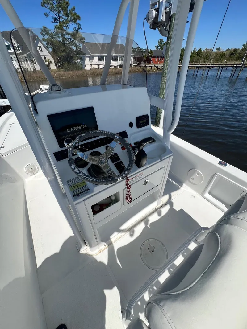Slide: The Image of 2015 Sea Hunt BX 22 BR boat console with steering wheel and Garmin display. - 13