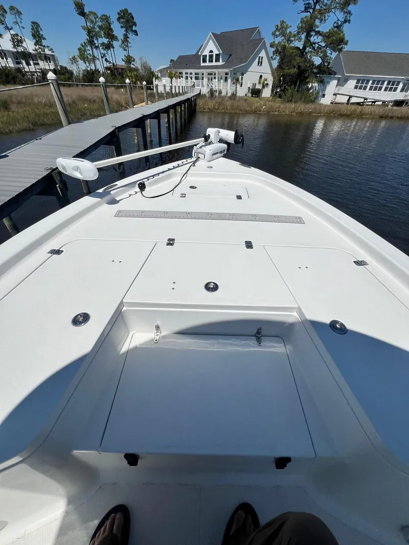 Slide: The Image of 2015 Sea Hunt BX 22 BR boat docked near waterfront homes. - 14