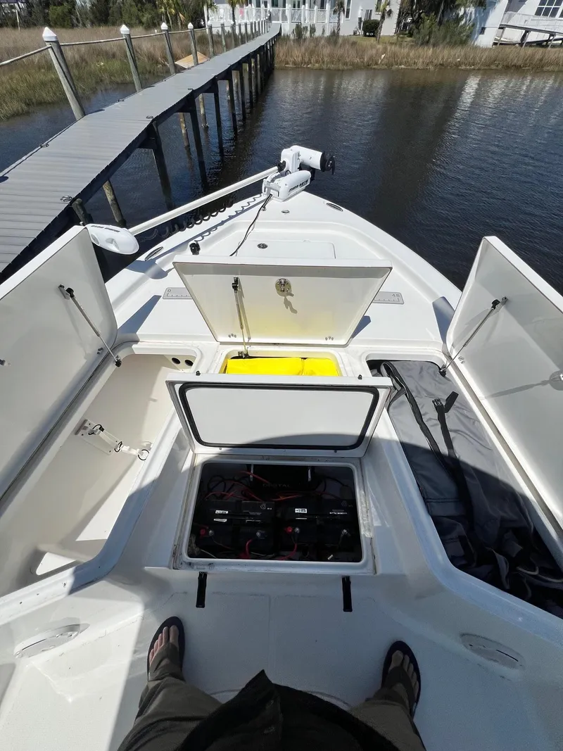 Slide: The Image of 2015 Sea Hunt BX 22 BR boat with open storage compartments, dockside view. - 15