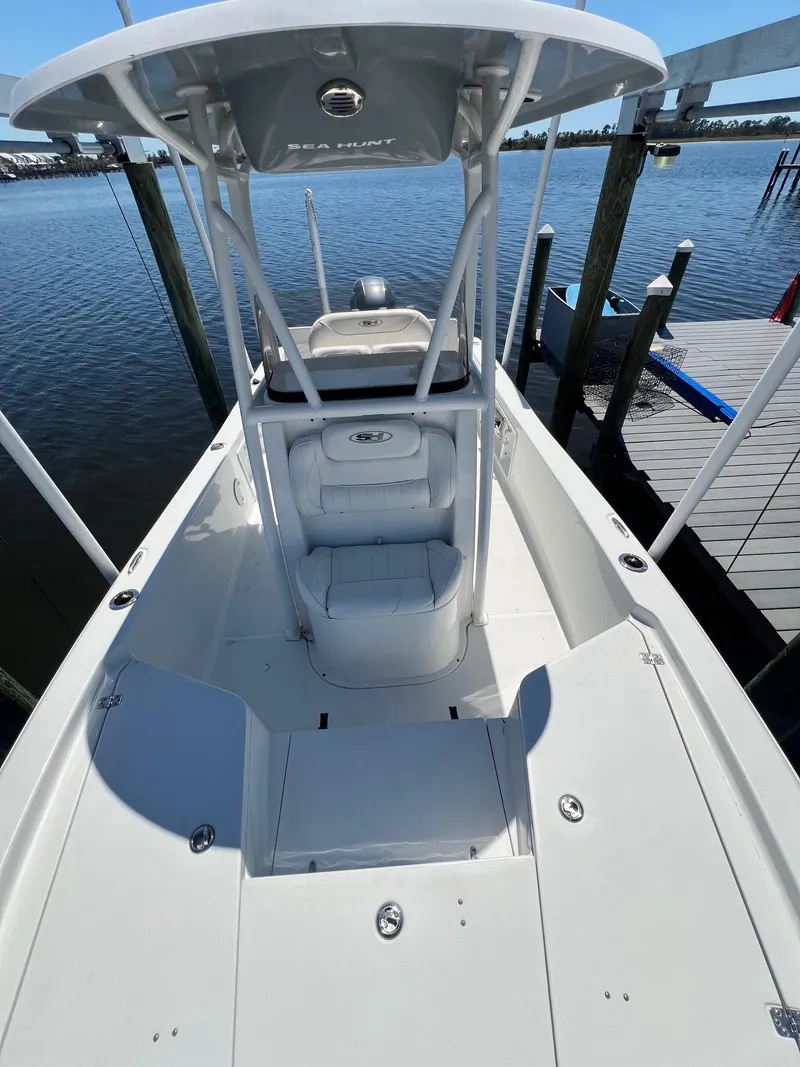 Slide: The Image of 2015 Sea Hunt BX 22 BR boat docked, featuring spacious deck and center console. - 20