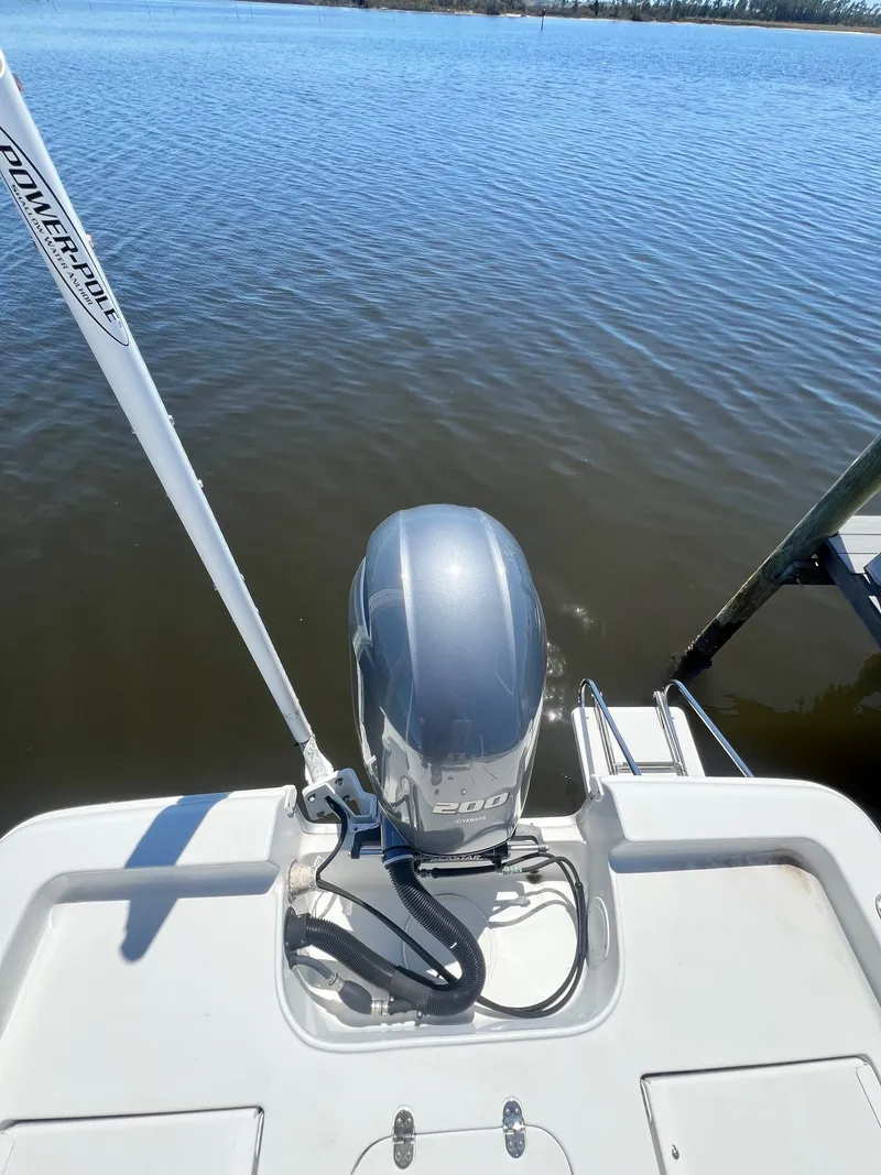 Slide: The Image of 2015 Sea Hunt BX 22 BR boat with outboard motor on calm water. - 24