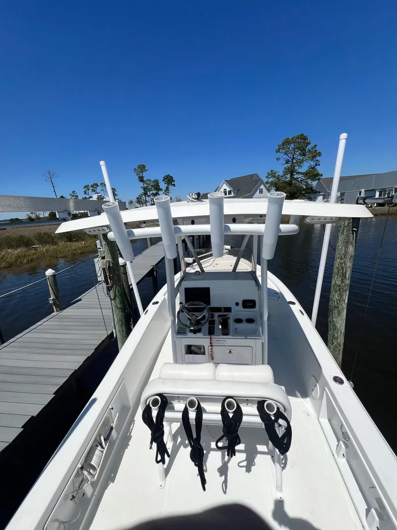 Slide: The Image of 2015 Sea Hunt BX 22 BR boat docked, featuring center console and rod holders. - 25