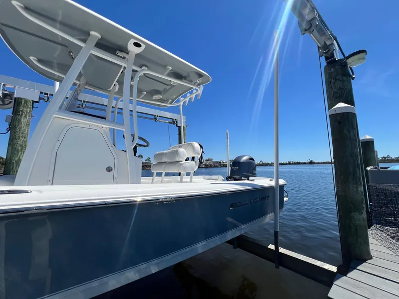 Slide: The Image of 2015 Sea Hunt BX 22 BR boat docked under clear blue sky. - 27