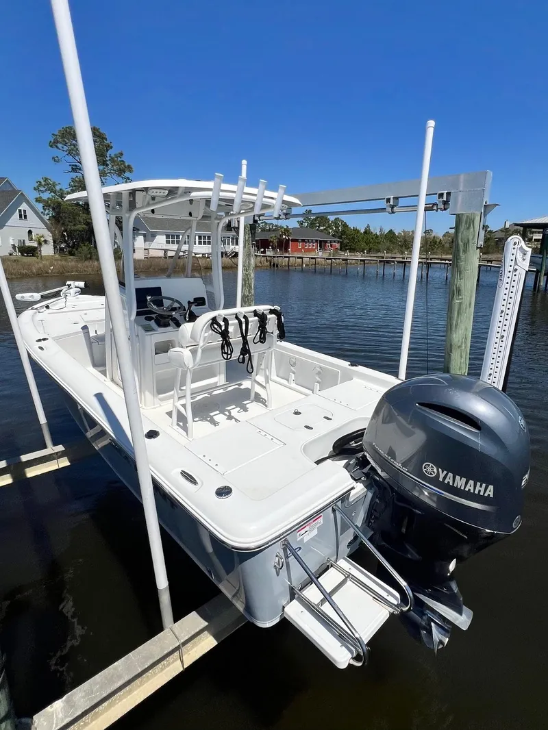 Slide: The Image of 2015 Sea Hunt BX 22 BR boat with Yamaha motor docked by waterfront homes. - 28
