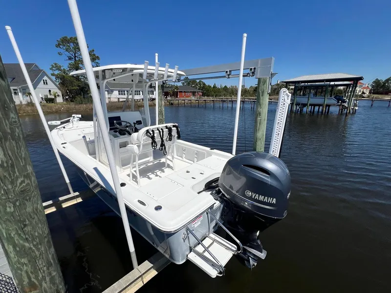 Slide: The Image of 2015 Sea Hunt BX 22 BR boat with Yamaha motor docked on a lift. - 3