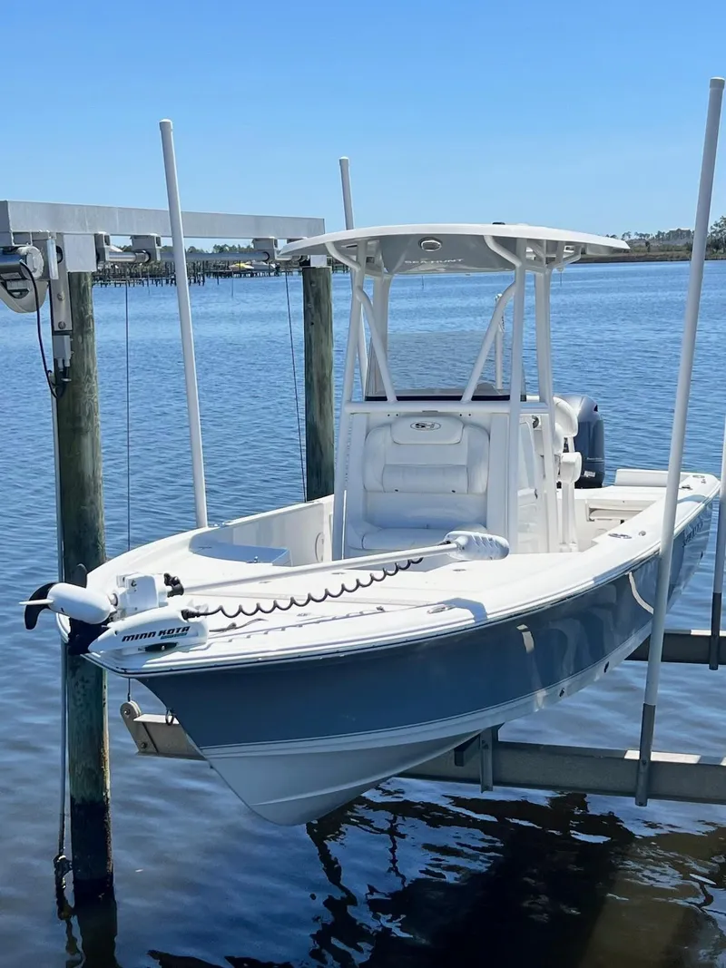 Slide: The Image of 2015 Sea Hunt BX 22 BR boat on lift, calm water background. - 30