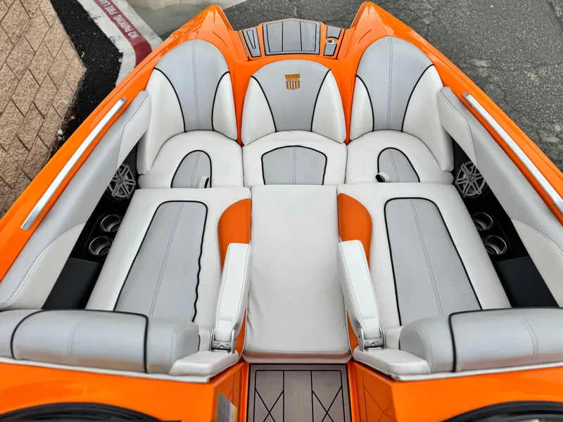 Slide: The Image of 2015 MasterCraft XStar boat interior with orange and white seating, showcasing luxury design. - 19