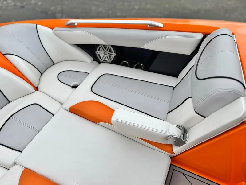 Slide: The Image of 2015 MasterCraft XStar interior with orange and white seating, featuring sleek design and premium materials. - 21