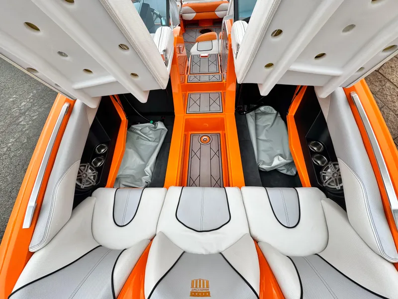 Slide: The Image of 2015 MasterCraft XStar interior with orange and white seating, showcasing luxury design and spacious layout. - 22