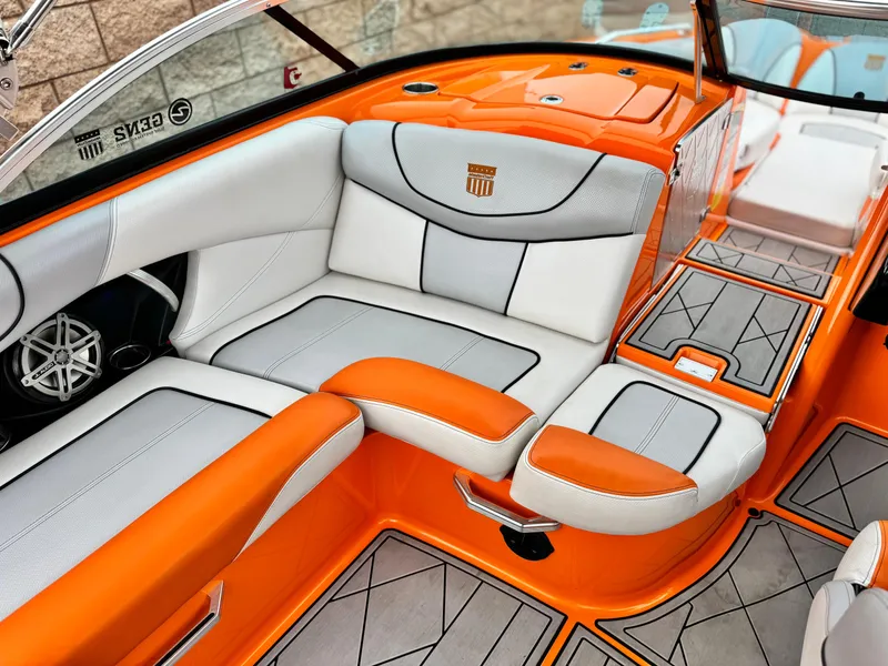 Slide: The Image of 2015 MasterCraft XStar interior with orange and white seating, showcasing modern design and comfort. - 29