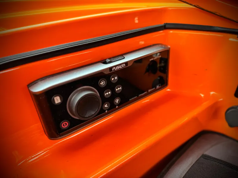 Slide: The Image of Control panel of a 2015 MasterCraft XStar boat, featuring a Fusion audio system. - 31