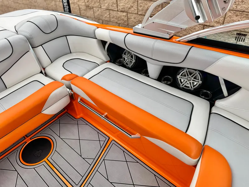 Slide: The Image of 2015 MasterCraft XStar interior with orange and white seating, featuring premium audio speakers. - 33