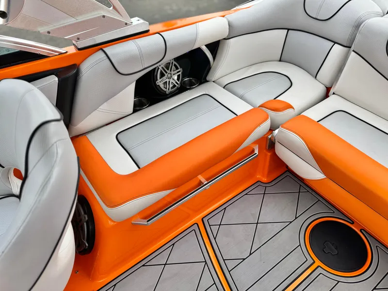 Slide: The Image of 2015 MasterCraft XStar interior with orange and white seating, featuring stylish design and premium materials. - 35