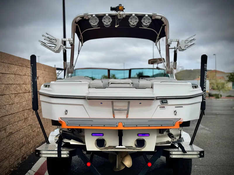Slide: The Image of 2015 MasterCraft XStar boat, rear view, showcasing speakers and wakeboard racks. - 4
