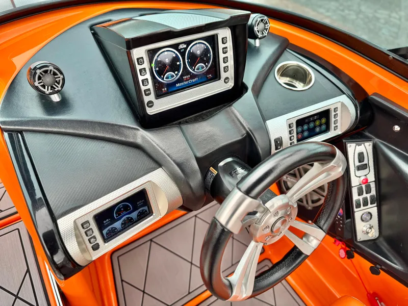 Slide: The Image of 2015 MasterCraft XStar dashboard with modern controls and sleek steering wheel design. - 45