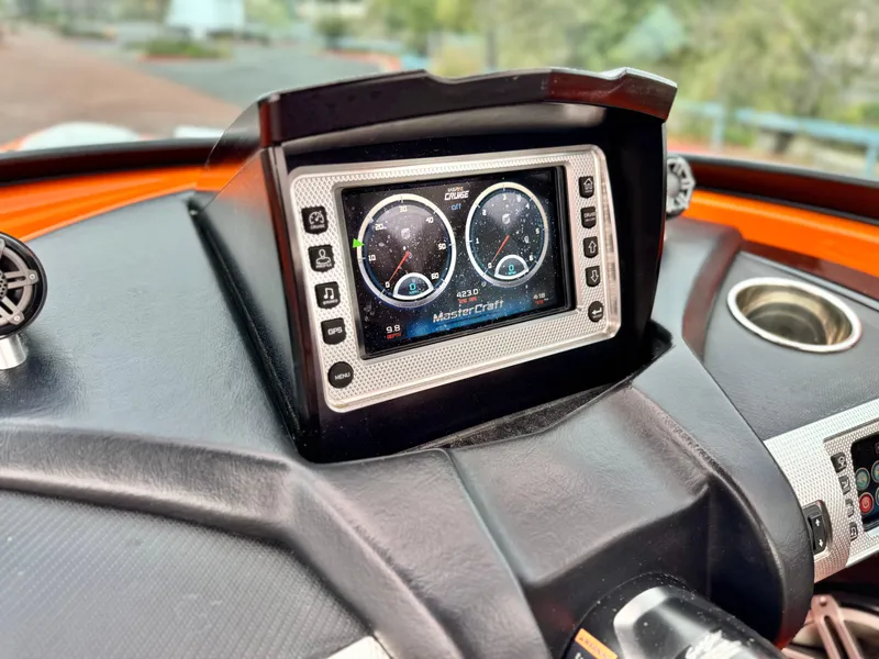 Slide: The Image of Dashboard of a 2015 MasterCraft XStar boat with digital display and controls. - 46