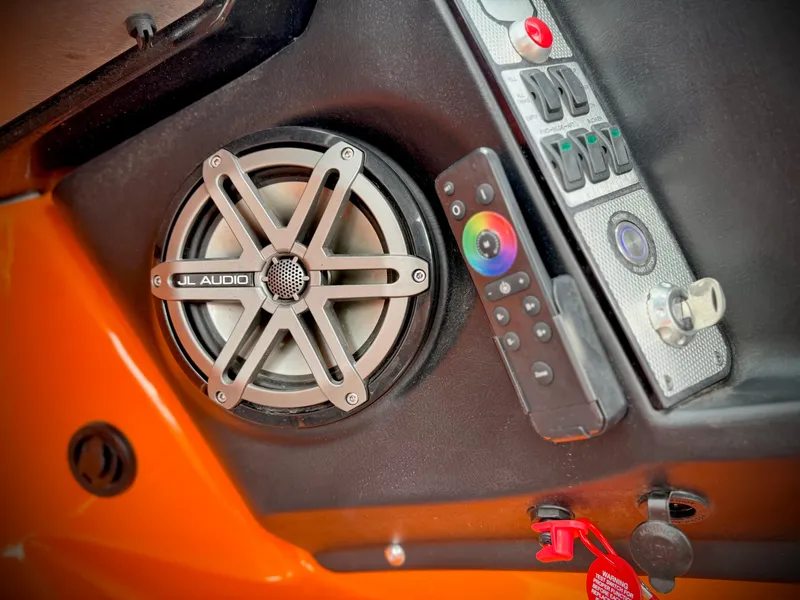 Slide: The Image of MasterCraft XStar 2015 boat dashboard with JL Audio speaker and remote control. - 49