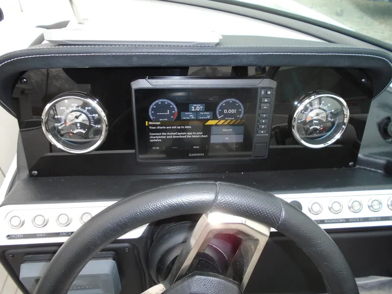 Slide: The Image of Dashboard of 2024 Crownline E 240 XS boat with gauges and digital display. - 11