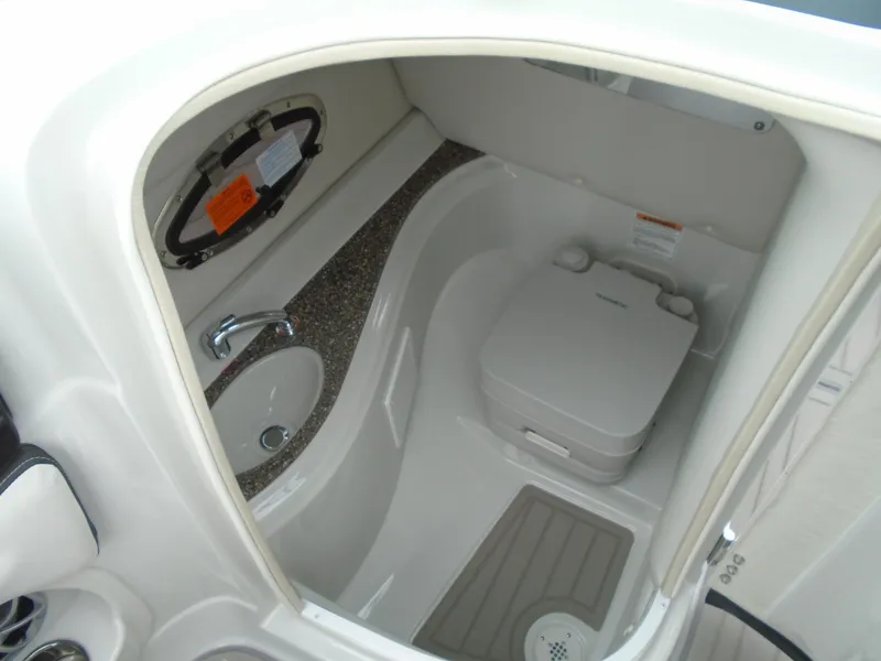 Slide: The Image of 2024 Crownline E 240 XS boat interior with compact bathroom and sink. - 13