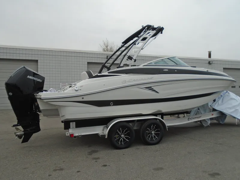 Slide: The Image of 2024 Crownline E 240 XS boat on trailer, side view, outdoors. - 3