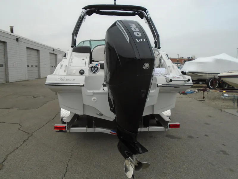 Slide: The Image of 2024 Crownline E 240 XS boat with powerful V8 engine, parked outdoors. - 4