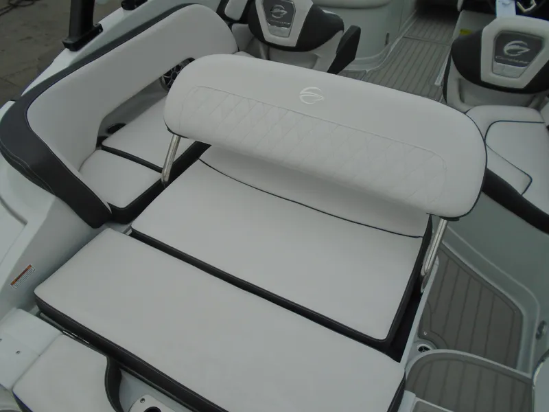 Slide: The Image of 2024 Crownline E 240 XS boat interior with white cushioned seating. - 9